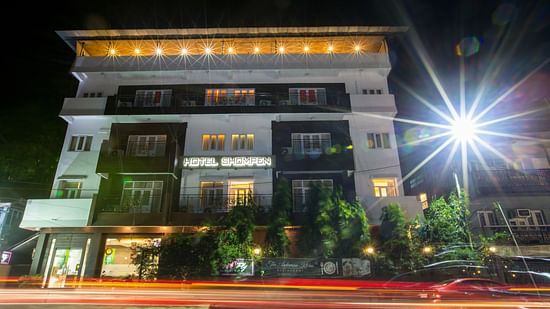 Facade of Hotel Shompen in the night with the lights on