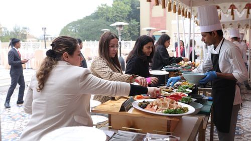 People taking food from the buffet counter  - Heritage Village Resorts & Spa