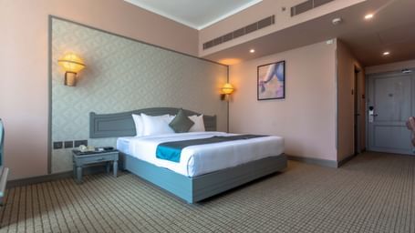  A contemporary guest room at Shilton International, Kochi featuring a large bed and tasteful furnishings.