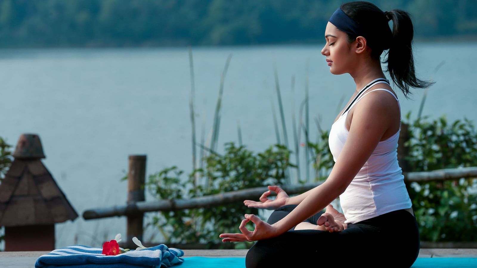 A woman practising meditation on the terrace