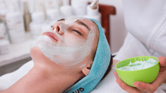 A person receives a facial treatment at a spa