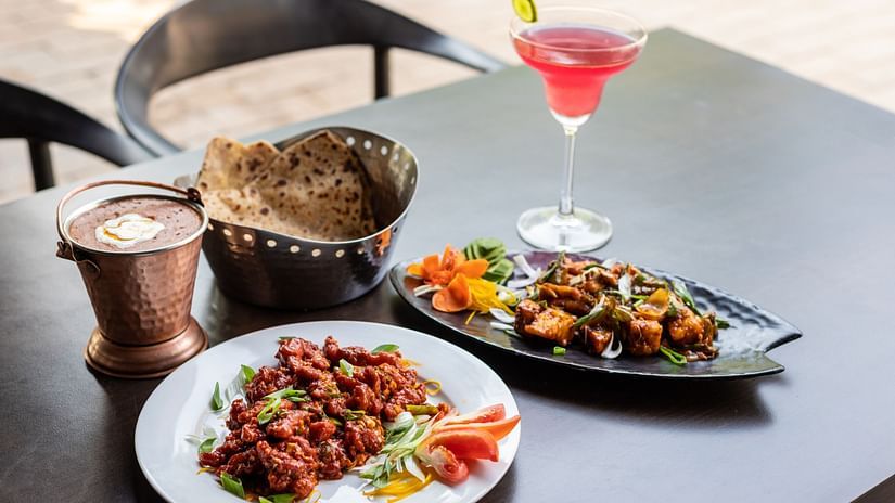 A full meal along with a refreshing drink served at our restaurant in Mandrem 