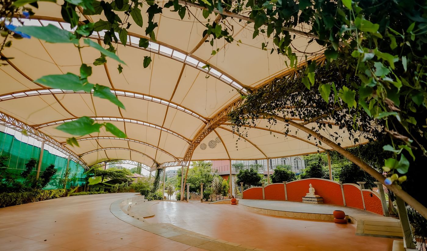 A view of the outdoor event space with the canopy and stage at Nirantara Resort & Spa.