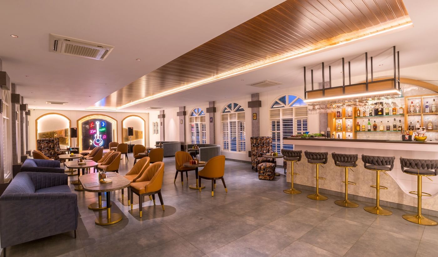 Stylish indoor bar and lounge seating at Nirantara Resort.