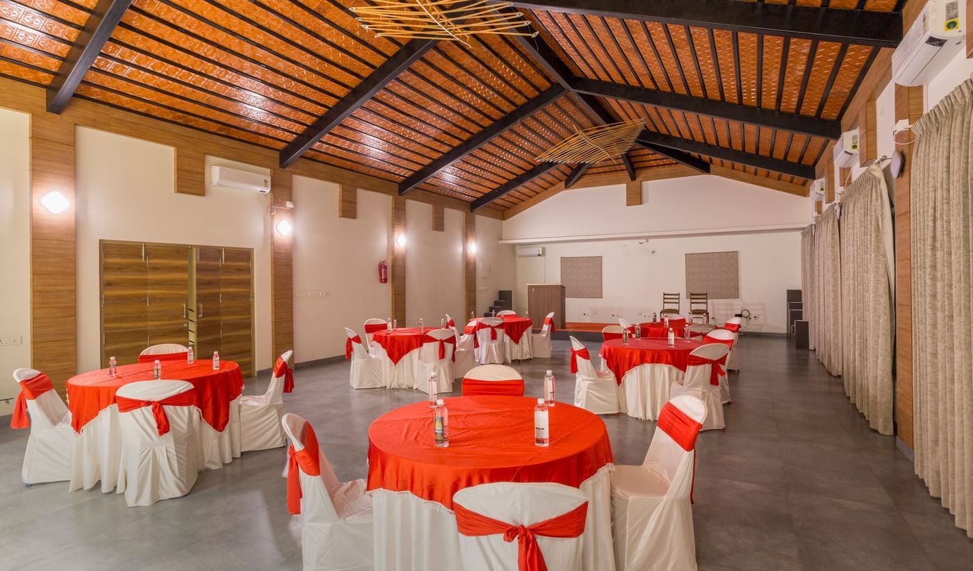Banquet hall with red and white table setup at Nirantara Resort.