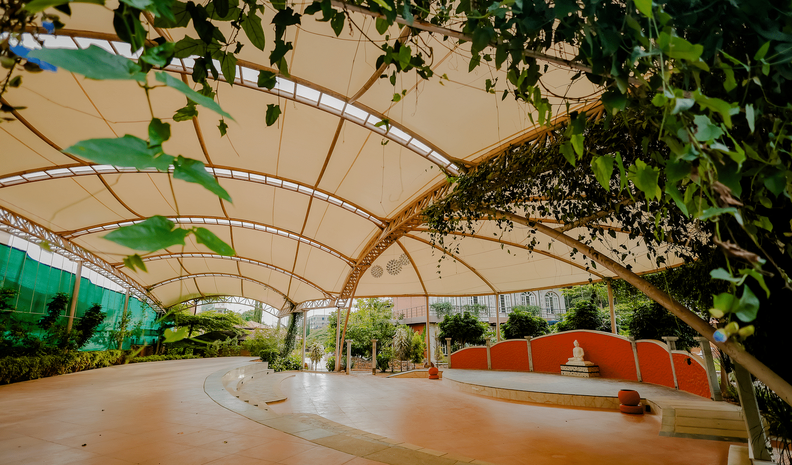 A view of the outdoor event space with the canopy and stage at Nirantara Resort & Spa.