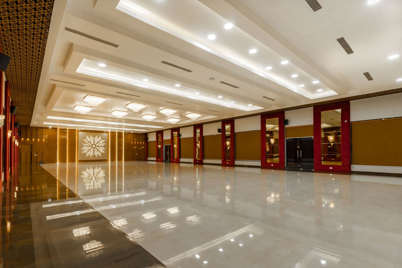 An angular shot of a long, empty hallway with a highly polished floor reflecting the ceiling and walls - Bamboo Saa Mulberry Resort, Pushkar