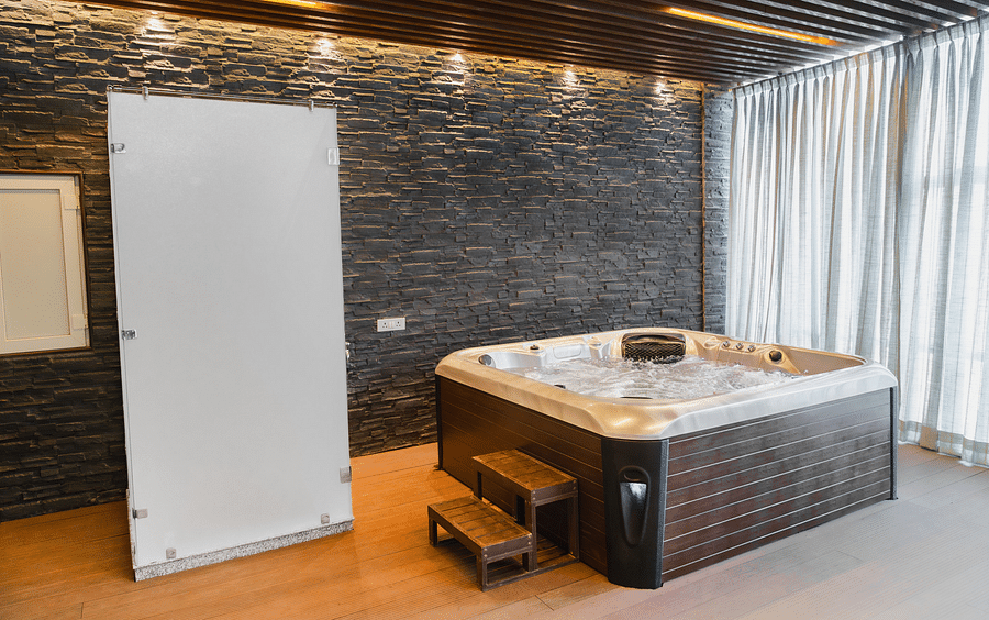 A jacuzzi placed in a room next to a wardrobe at Montclair Ananta, Elite.