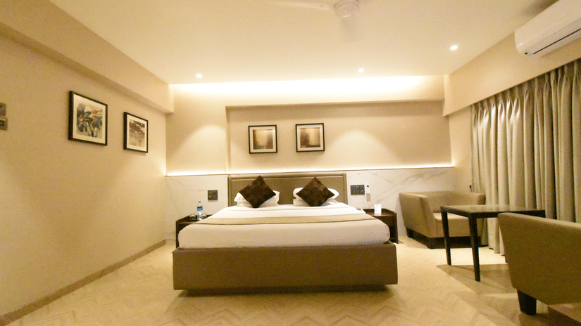 Spacious deluxe room with a double bed and modern interiors at Kings International Juhu