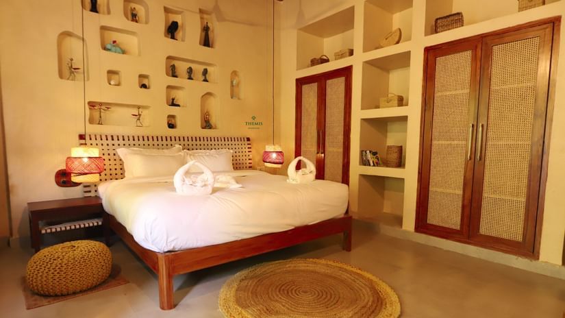 a view of a bedroom decked with rustic furnishing at Themis Mudhouse - A Nature's Retreat Resort & Wellness