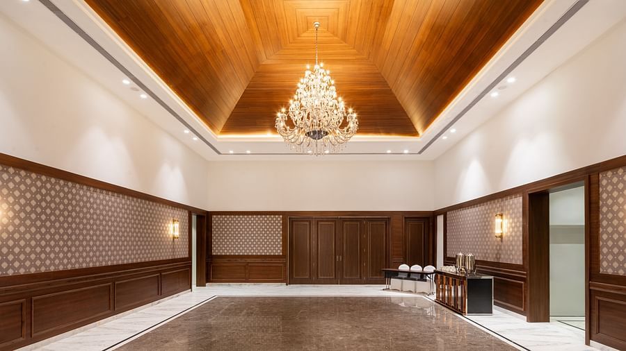 A pre-function hall in Haridwar, featuring a chandelier hanging from a wooden ceiling and offering a spacious area for gatherings - MJ Sarovar Portico, Haridwar