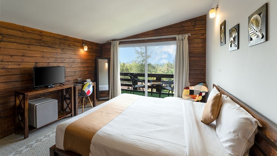 Cosy bed with stylish interior design and view from the window at Stone Wood Resort, Mandrem