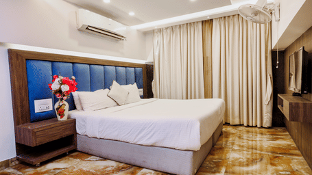 Spacious bedroom with a large comfortable bed and soft lighting at Kumar Resort by Turtle.