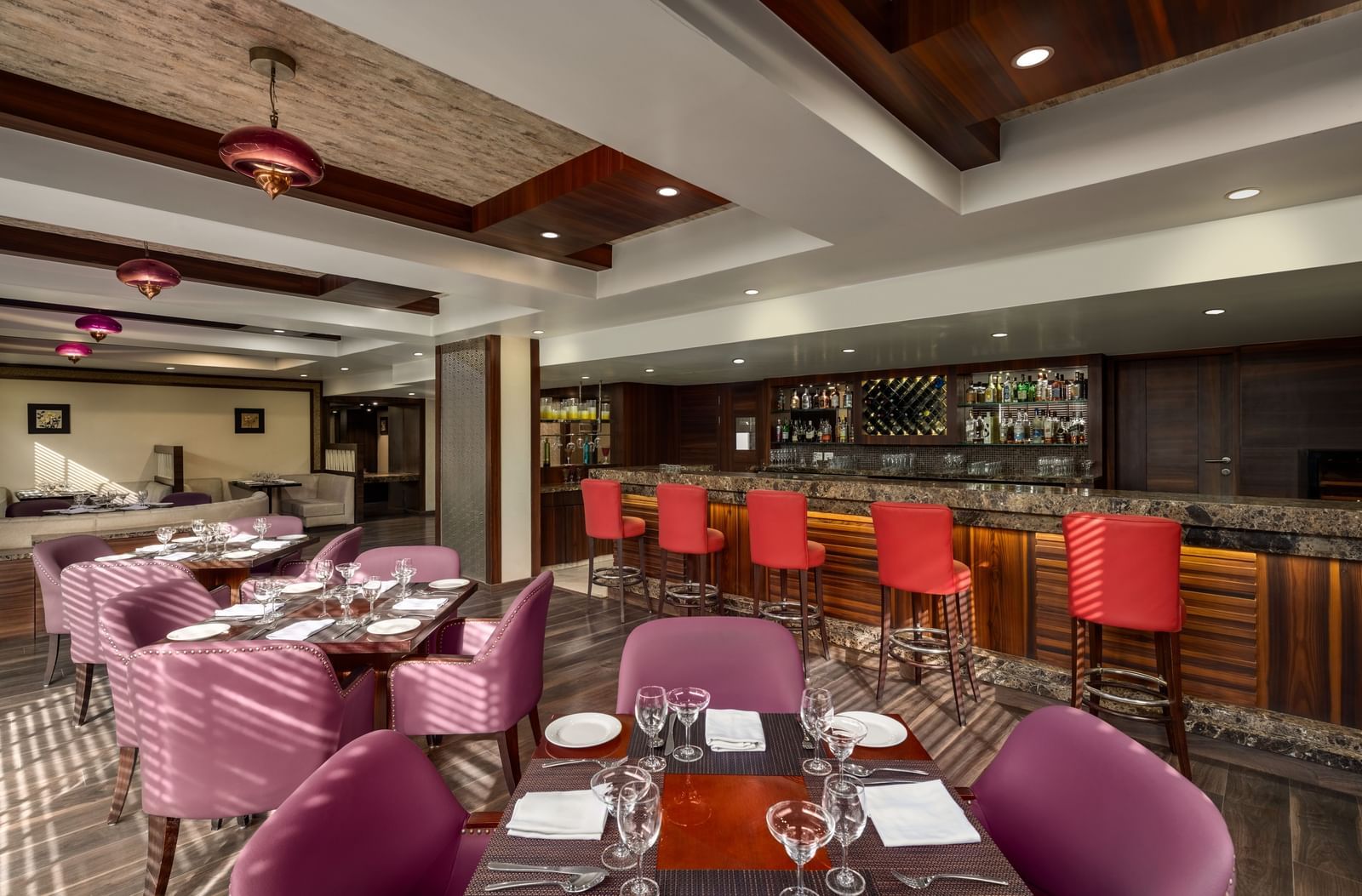  Restaurant interior with purple seating and contemporary lighting at Ramada by Wyndham Ghaziabad Vasundhara