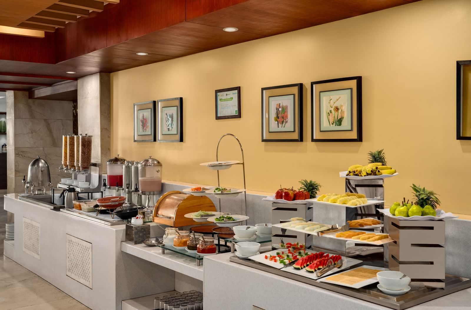 Breakfast buffet area with fresh food display and dining setup at Ramada by Wyndham Ghaziabad Vasundhara