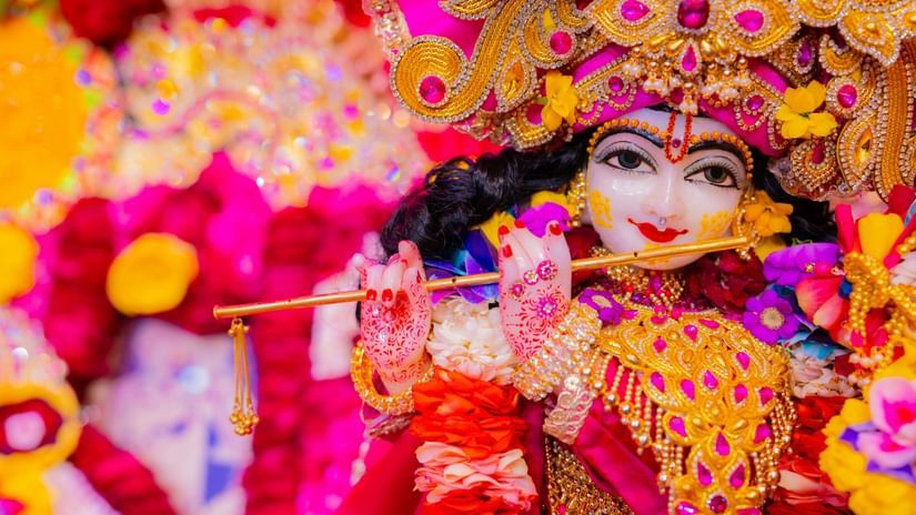 A close-up, vibrant and highly detailed photograph of a statue of the Hindu deity Krishna.