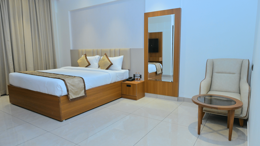 Bedroom of Bhavanis Vista By Icon featuring a bed, a headboard, and a door.