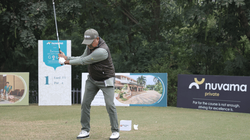An image of a man playing golf in a golf course at Heritage Village Resort and Spa