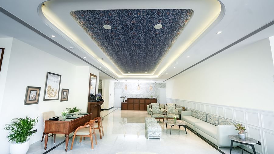 An image of a lobby with a cosy sofa, a wooden reception desk, elegant furniture, and potted plants enhancing the ambience - NAMAMI BY ZENQ BANKHANDI