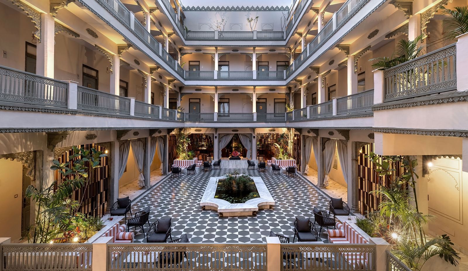 An overview of a courtyard with the inside of the building in view - Manuscript - Jhilwara Haveli, Udiapur