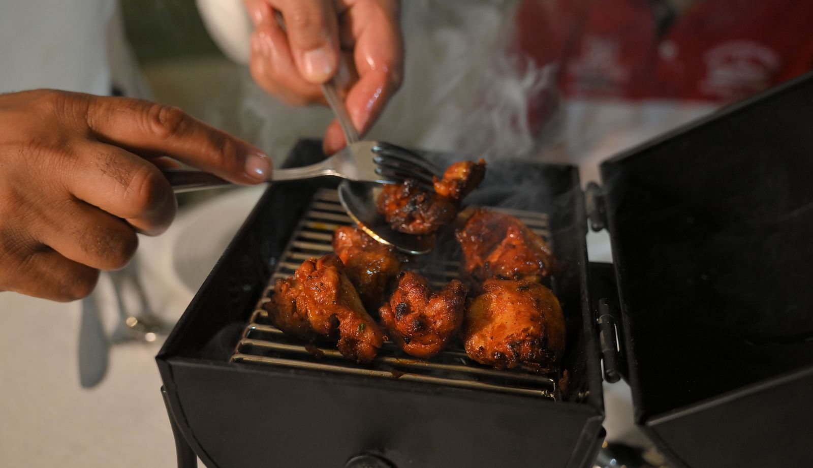 Chef grilling fresh tandoori delicacies live at Royal Comfort Regency, bringing authentic flavours straight to your table.
