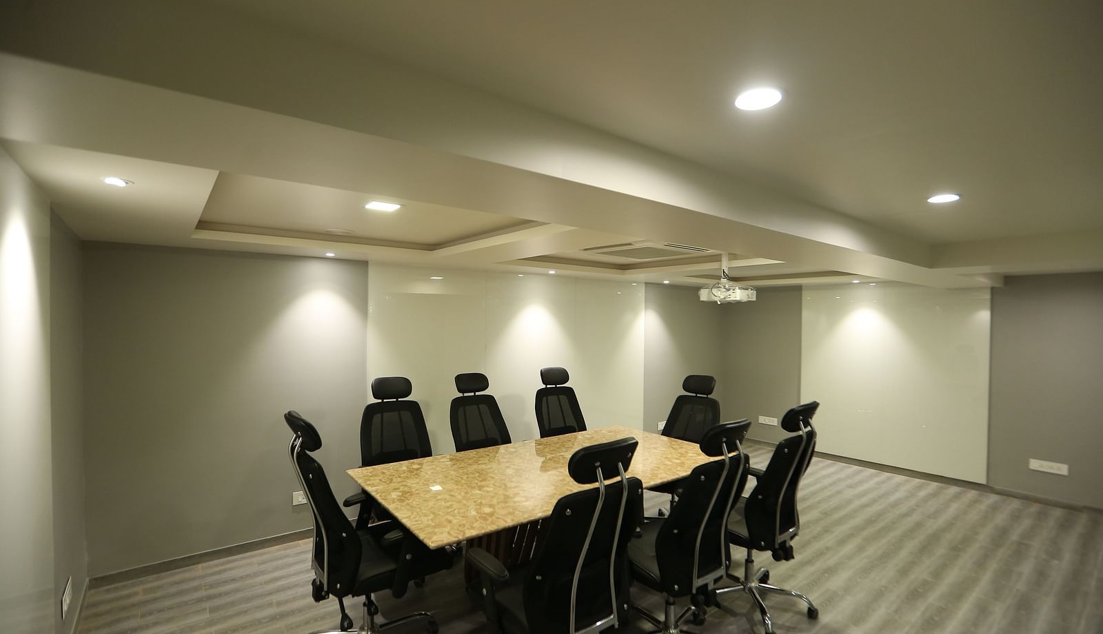 A meeting room setup with a long conference table and chairs - TGI SPS Grand, Coimbatore