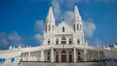 Velankanni Church in Tamil Nadu featuring two storey building and tall extensions on both side of the main building.