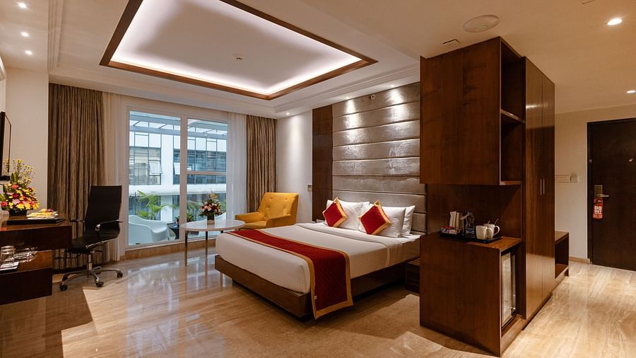Spacious side view of executive room with a king-size cozy bed and interior lighting at Icon Premier Hotel by Bhagini, Devarabisanahalli