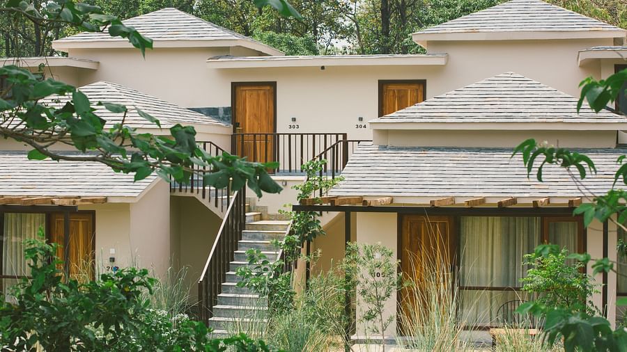 Exterior of the villas at Saraca Resort & Spa Corbett surrounded by trees