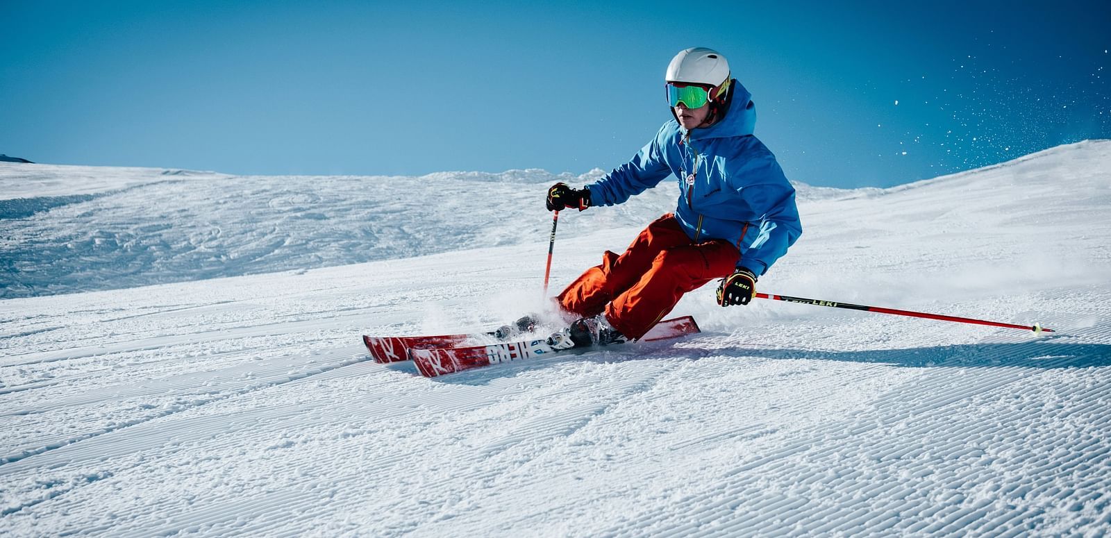A person skiing down a snow-covered slope.