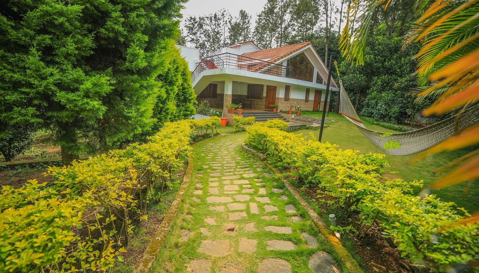 Facade of WOW Bungalow surrounded by plants and trees at WOW Bison Woods.