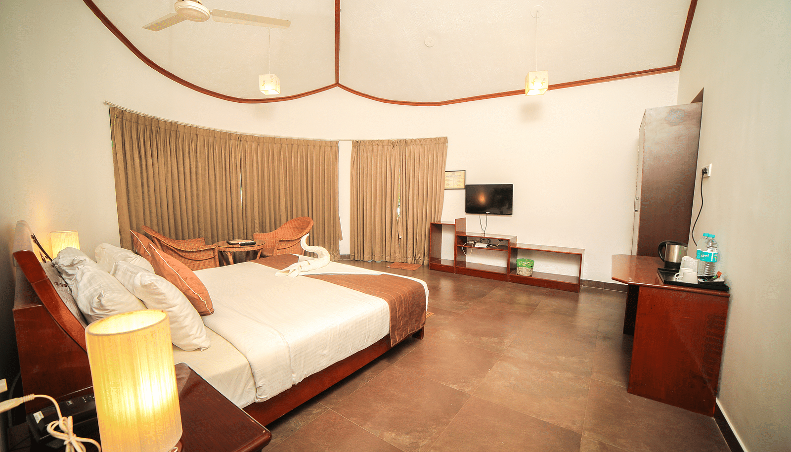 Image of a room with a bed and a television in front at WOW Bison Woods.