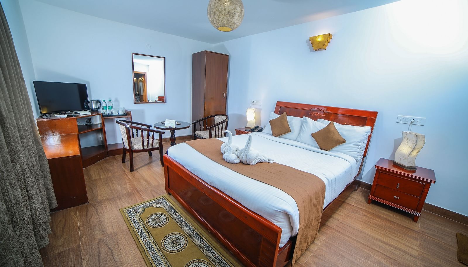 Image of a room with a bed and a television in font at WOW Bison Woods.