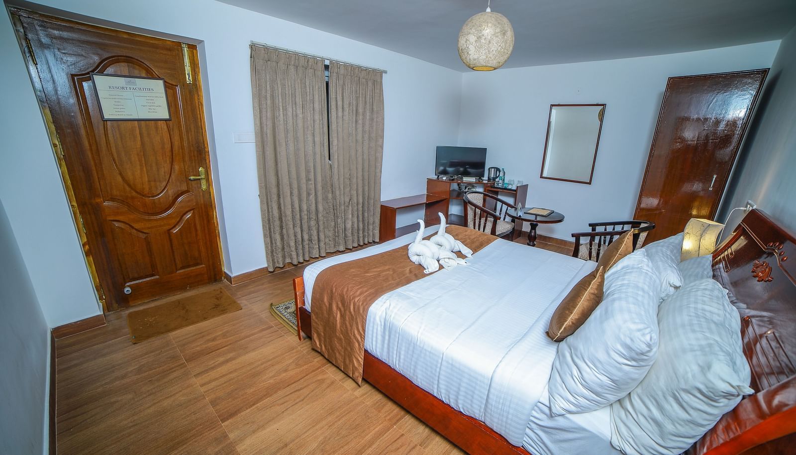 Side view of a room with a bed, a door, and window in front at WOW Bison Woods.