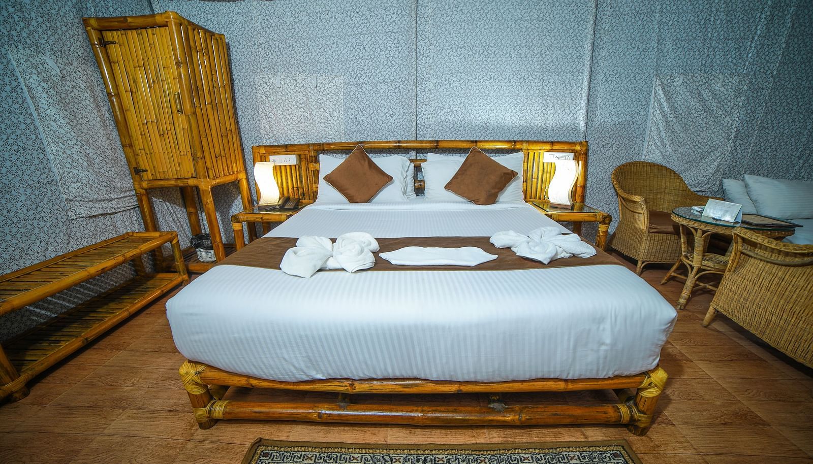Image of a room with a bed and a wooden wardrobe on the side at WOW Bison Woods.