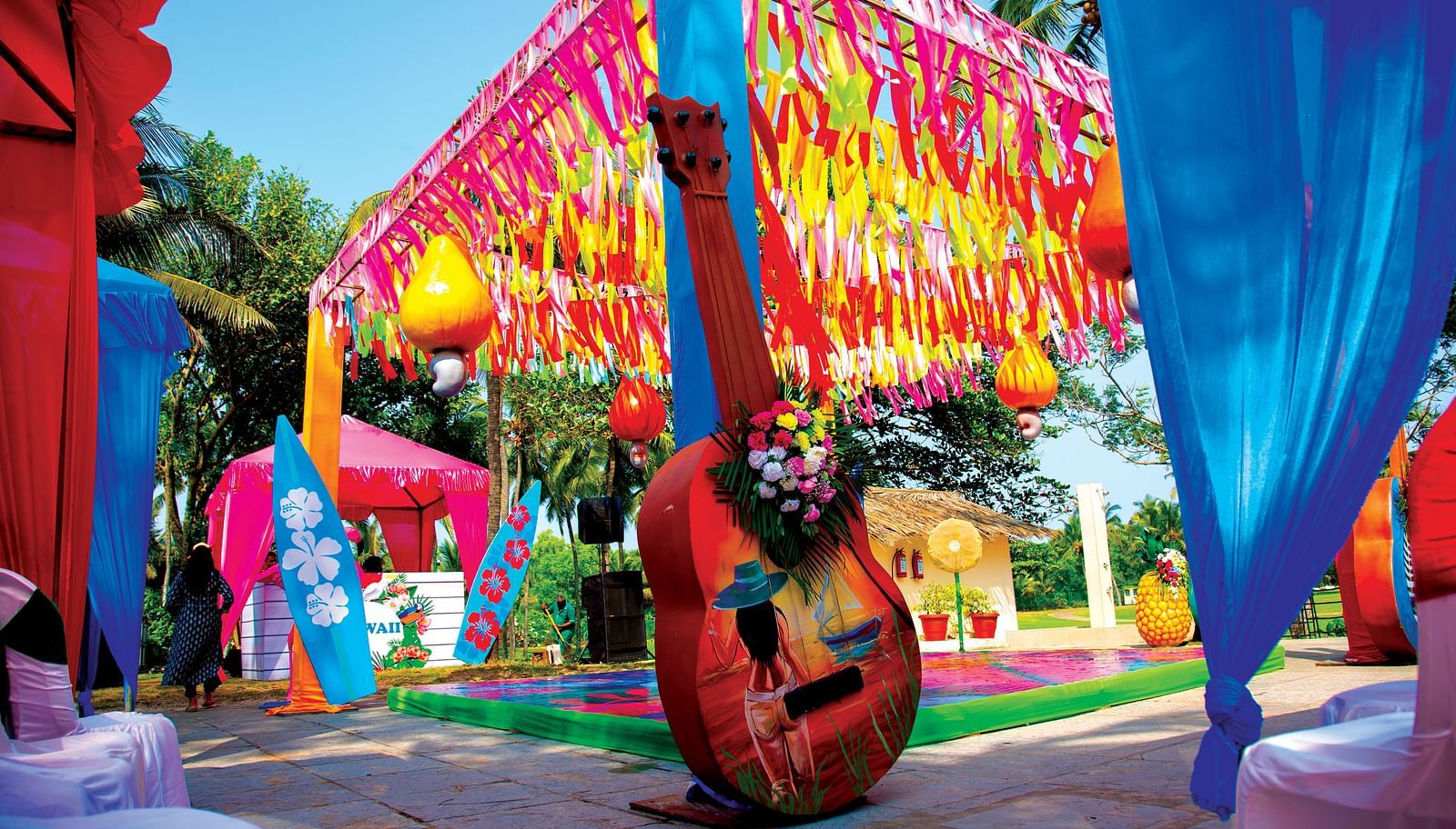 a decorated tent with flowers and a guitar - Caravela Beach Resort Goa