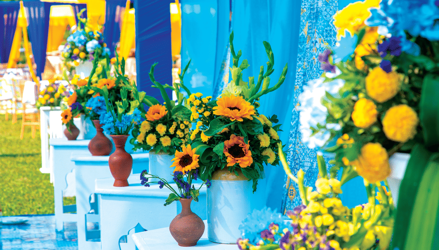 many vases with different flowers kept on tables - Caravela Beach Resort Goa