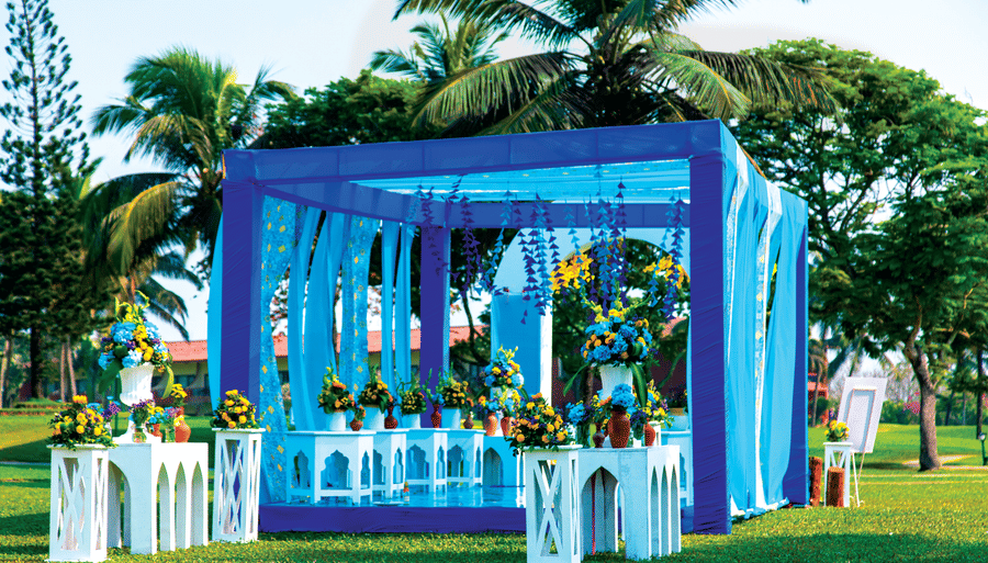 a decorated stage area with seats inside it - Caravela Beach Resort Goa