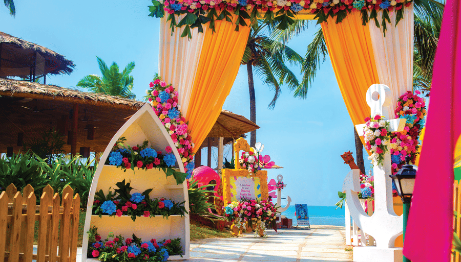 entrance to the wedding with flowers decorated aesthetically - Caravela Beach Resort Goa