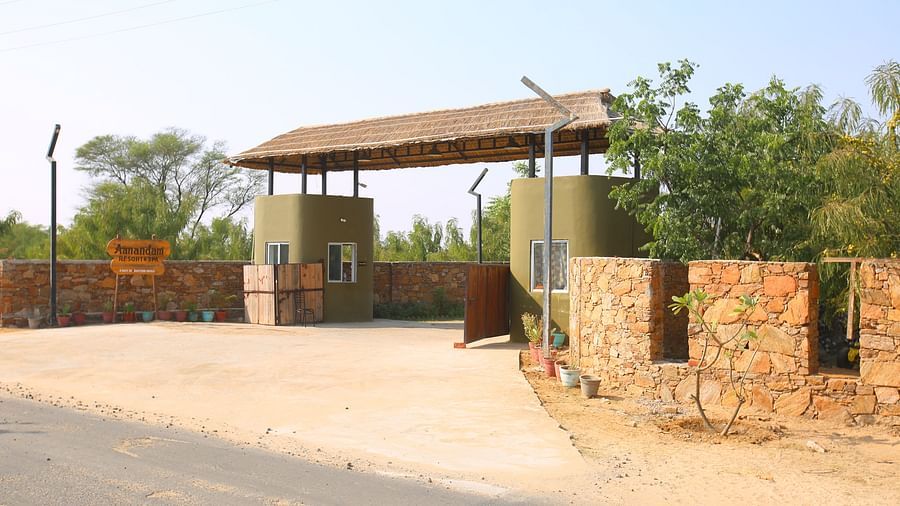 Exterior view of the hotel's entryway at Aanandam Resort & Spa, surrounded by trees