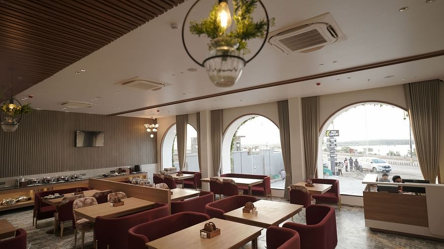 Dining arrangement in the restaurant at Pride Comfort, Dwarka