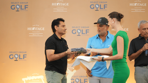 Award ceremony at a golf event, with a participant being recognised on stage.