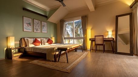Spacious bedroom with cosy lighting, artwork, and natural wooden elements at Kssemya.