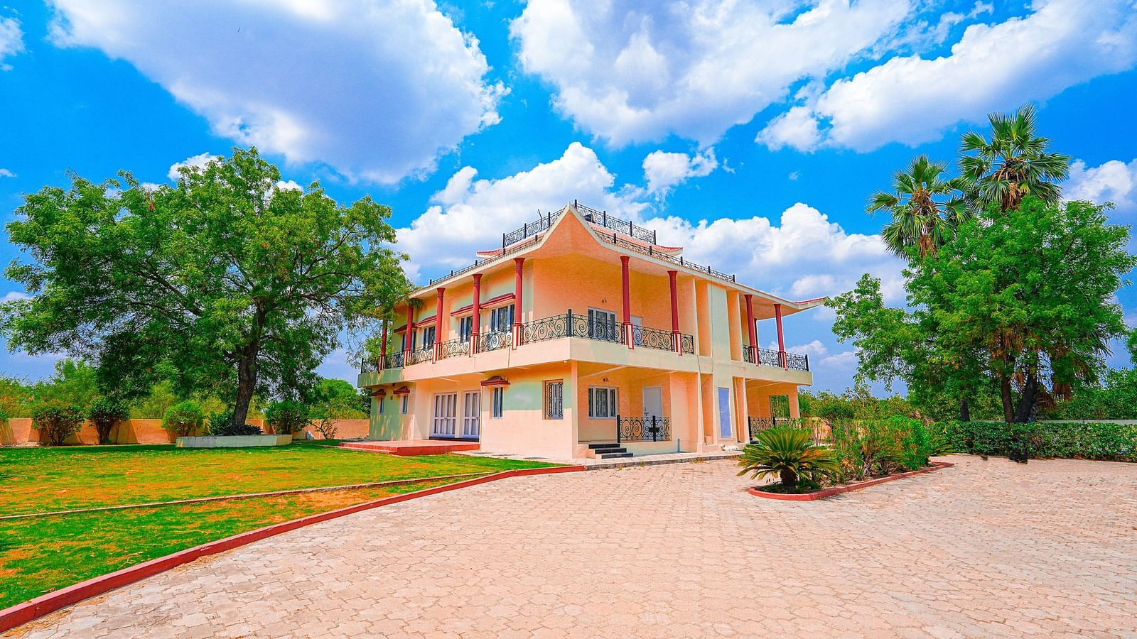 Exterior view of Vasundhara Villa on a cloudy day