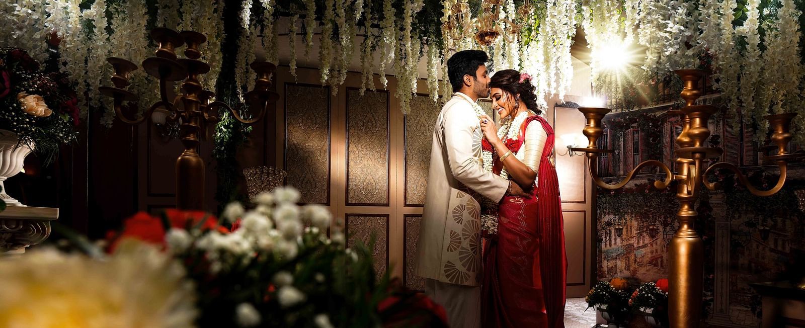 Couple getting married where the groom is kissing the bride's forehead at Grand Chennai By GRT Hotels. - Best Hotel near US Consulate Chennai