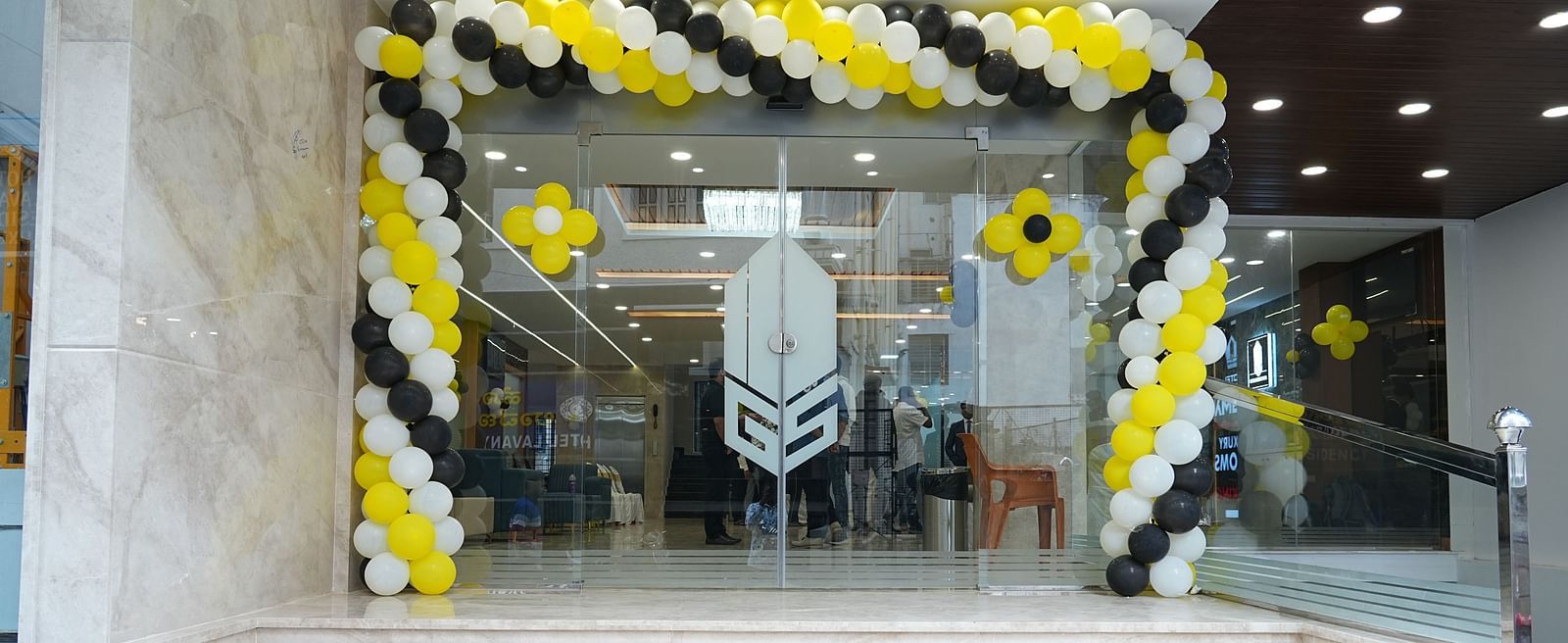 a staircase leading to the entrance of our hotel in Bangalore decorated with balloons - Hotel Grand Sigma