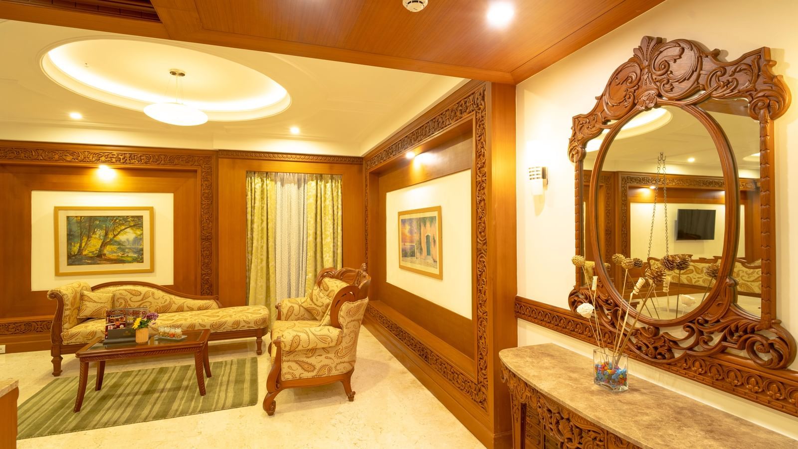 Room with a mirror, seating area, and soft ceiling lights.