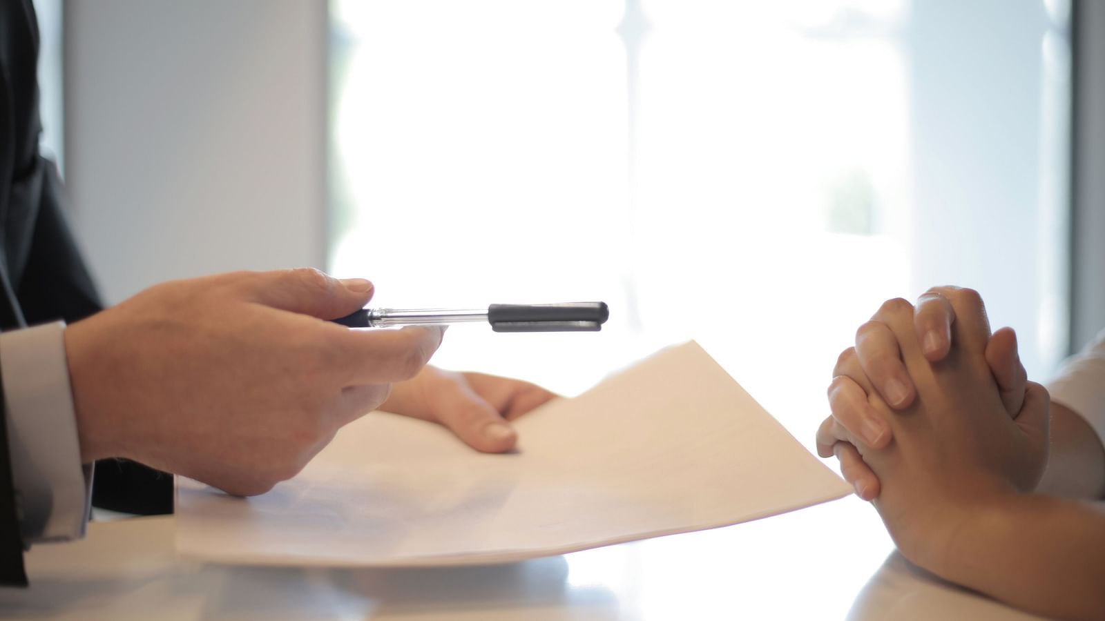 Man handing out pen and paper 