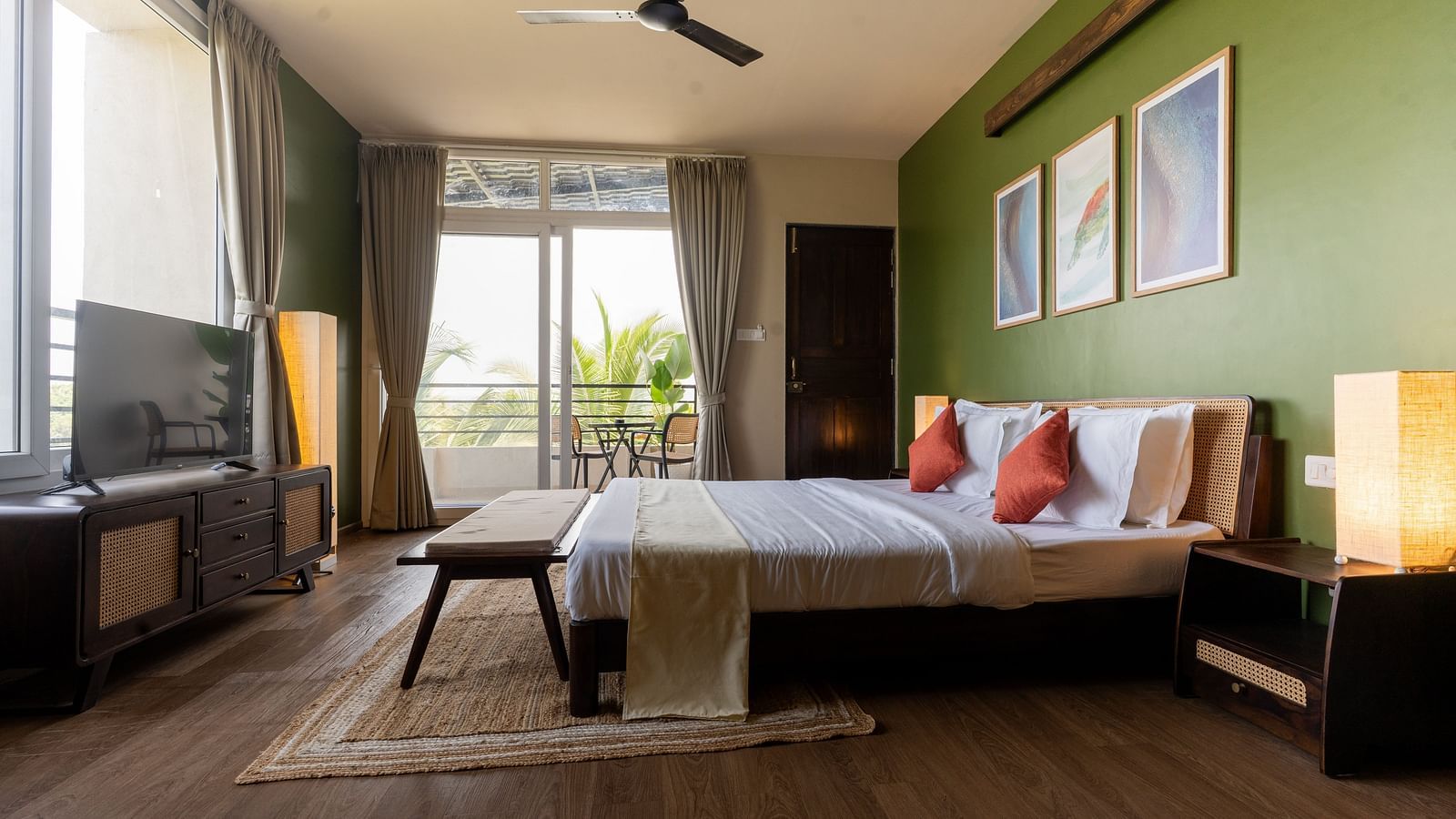Spacious bedroom with natural lighting, modern decor, and a cosy seating area at Kssemya.