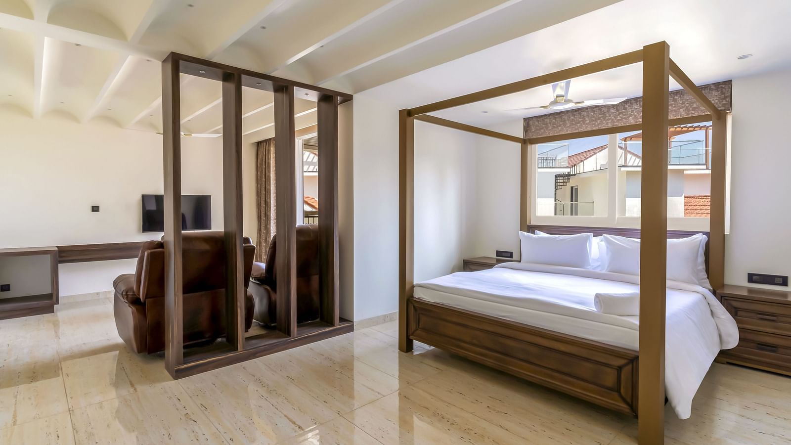 A double bed with wooden beams inside one of the rooms - The Tanisi Hotels & Resorts, Goa